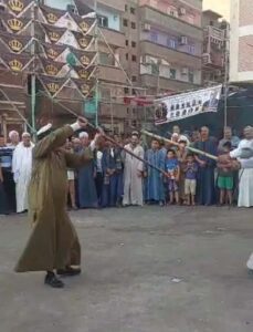 “التحطيب” تراث شعبي موروث يسير البهجة على أرض سلطان الصعيد بمولد الفرغل في أسيوط